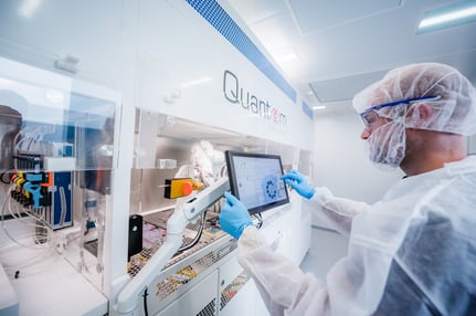 Laboratory technician operating the NfinityTM platform from Quantoom Biosciences
