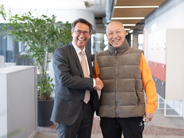 Mr. Tóth and Mr. Li (right) after signing the new partnership